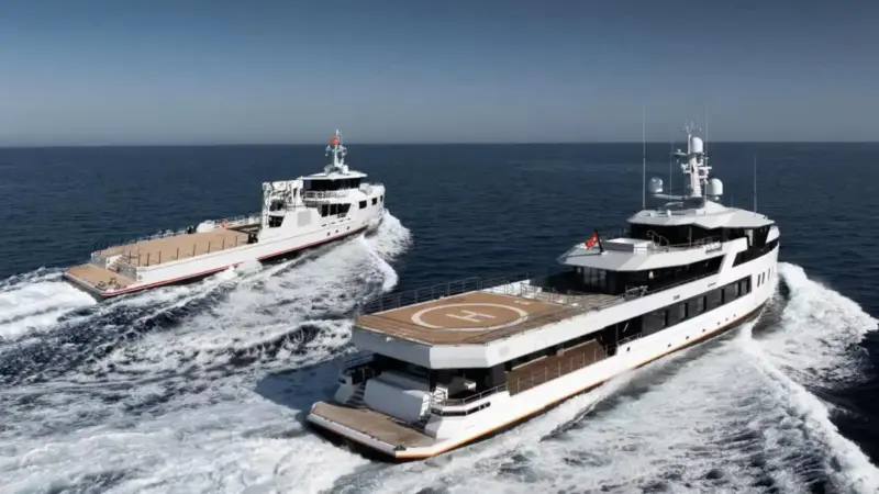A secretive billionaire takes delivery of twin superyachts on the same day: a 197-foot Ice-class explorer and a 175-foot support vessel built for adventure over extravagance
