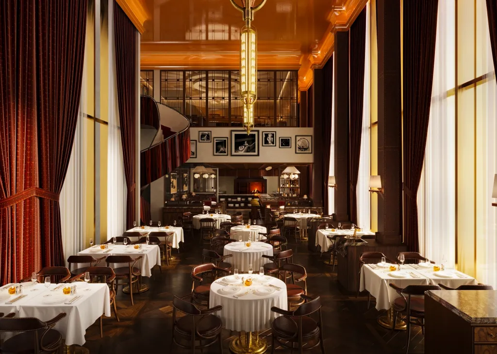 Elegant restaurant interior with round white-clothed tables, dark leather chairs, tall windows with red curtains, and a mezzanine gallery above.