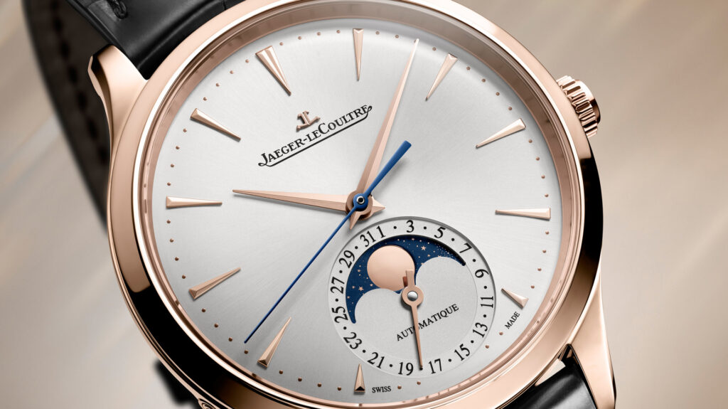 Close-up of a Jaeger-LeCoultre Master Ultra Thin Moon watch in pink gold with a moonphase dial and black leather strap.