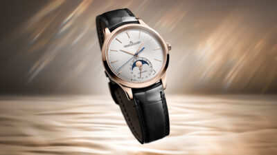 A Jaeger-LeCoultre Master Ultra Thin Moon watch with pink gold case, white dial, moonphase display, and black leather strap.