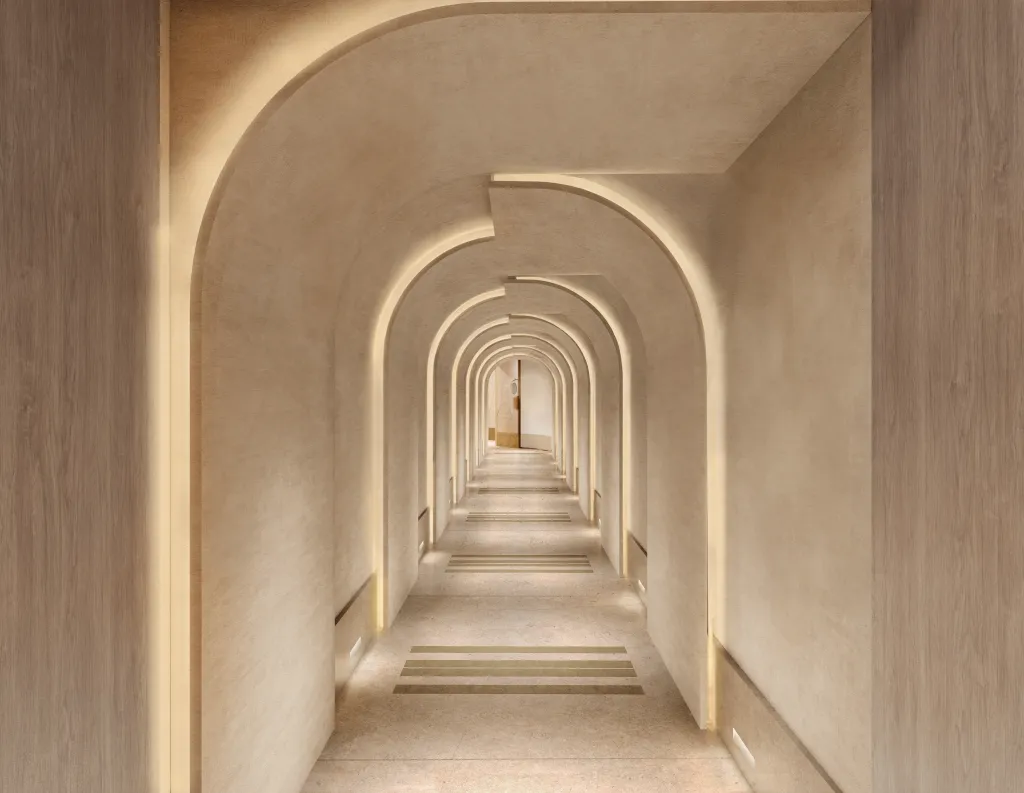 A minimalist corridor with a series of illuminated arches leading to a doorway.